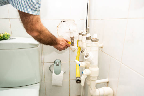 istock Human hand closes yellow gas valve at home. 1345990384