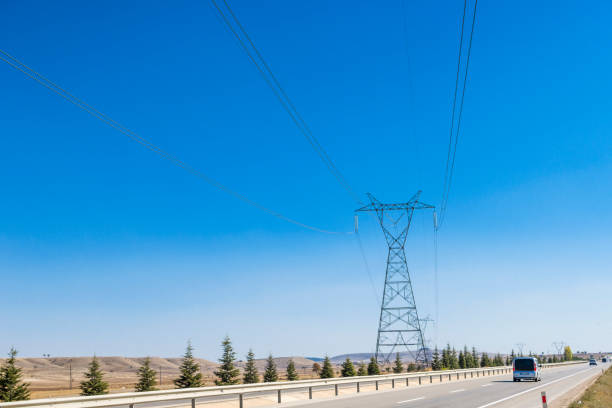 istock High voltage towers with thick hanging power cables in a rural landscape 1345991600