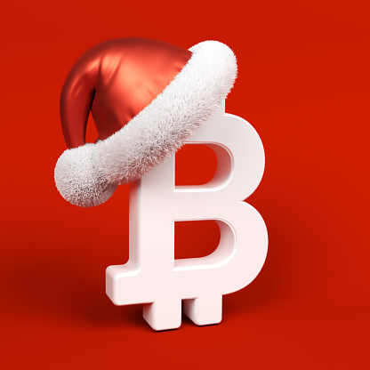 White-colored Bitcoin symbol and Santa Claus hat. On red-colored background. Square composition with copy space. Isolated with clipping path.