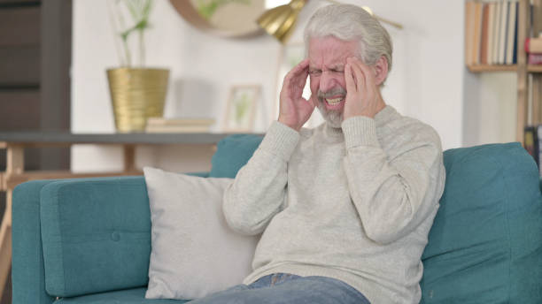 istock Stressed Senior Old Man with Headache at Home 1345994943