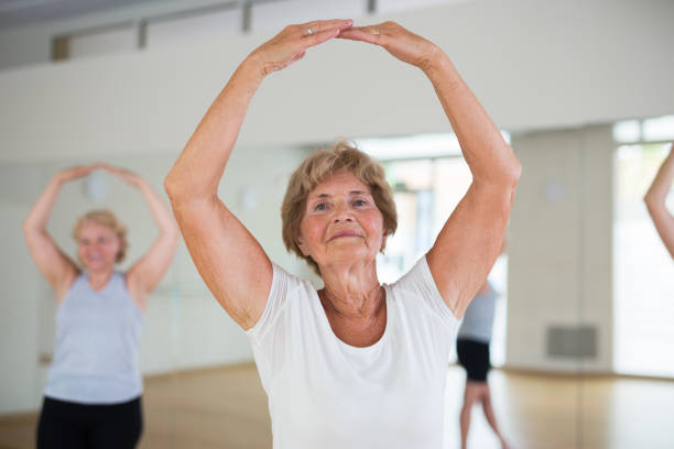 istock Mature active women perform ballet exercises in the studio 1345995578