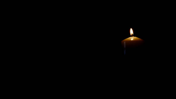 istock light candle isolated on black background right side of picture 1345995886