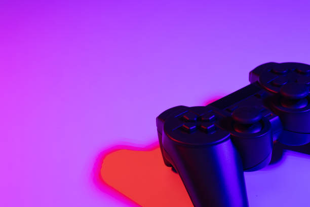 istock Accessory gaming joystick with blank space. Gadget for gamer playing video game online in the neon light darkroom. 1345997830