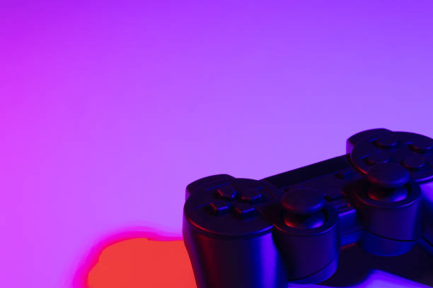 istock Accessory gaming joystick with blank space. Gadget for gamer playing video game online in the neon light darkroom. 1345997832