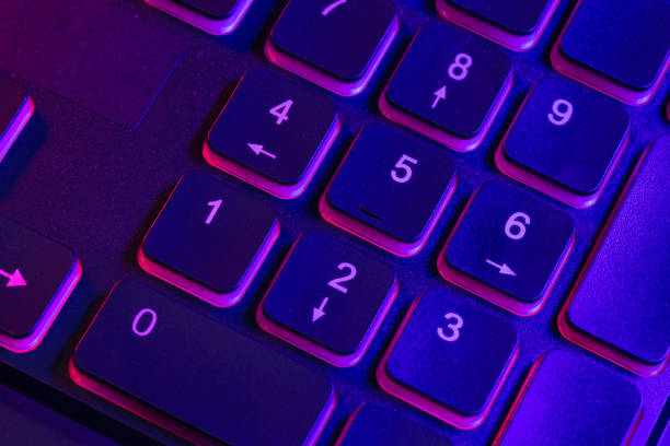 istock Accessory gaming keyboard with blank space background. Gadget for gamer playing video game online in the neon light darkroom. 1345997870
