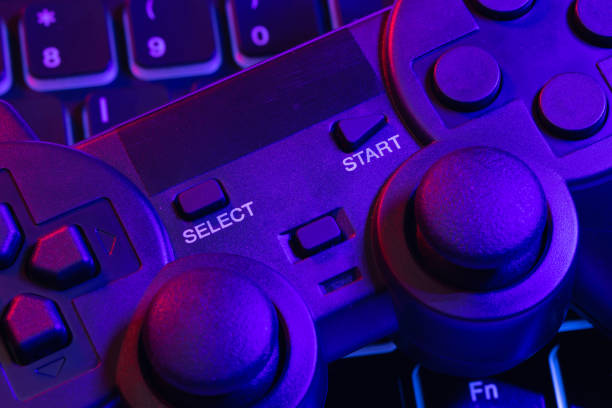 istock Accessory gaming keyboard joystick mouse headphone with blank space. Gadget for gamer playing video game online in the neon light darkroom. 1345997906