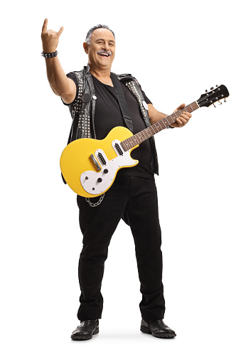 Mature guitarist with an electric guitar gesturing a rock and roll sign isolated on white background