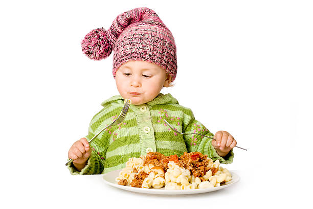 istock Cute child eating with two plugs; isolated over white 134599861