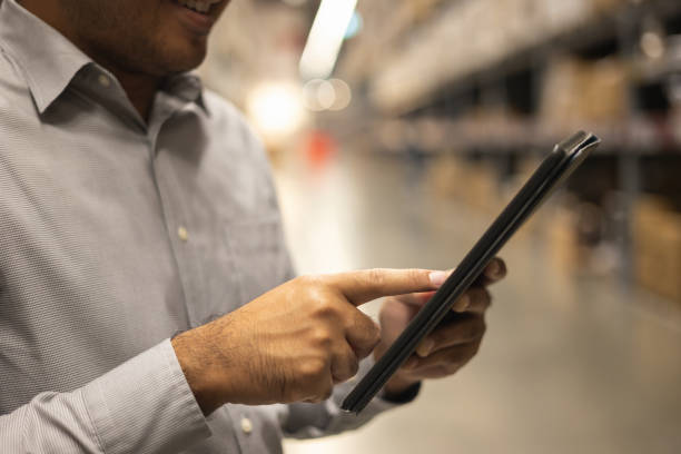 istock Young manager worker checklist manage parcel box product in warehouse. Asian supervisor man using tablet working at store industry. Logistic import export concept. 1345998840