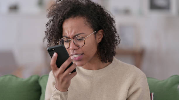 istock Angry Young African Woman Talking on Phone 1345998959
