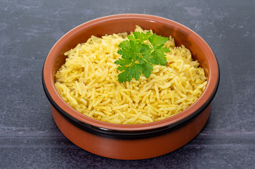 Indian Pilau rice in a terracota bowl