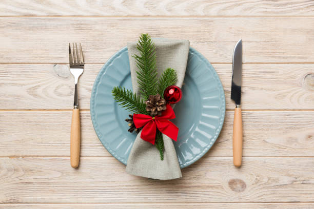 istock Christmas table place setting with christmas decor and plates, kine, fork and spoon. Christmas holiday background. Top view 1346001916