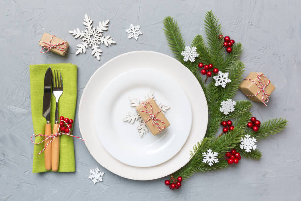 istock Christmas table place setting with christmas decor and plates, kine, fork and spoon. Christmas holiday background. Top view 1346001920