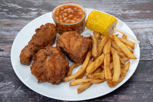 Fried chicken with fries, baked beans and sweetcorn dinner