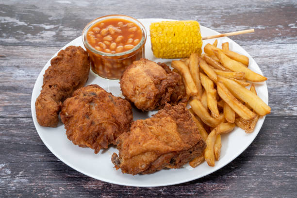 istock Fried chicken dinner with fries, corn and beans 1346002231