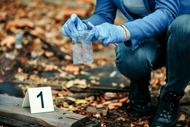 istock Detective on murder crime scene collecting evidence 1346004557