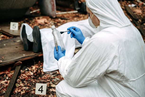istock Forensic scientist looking for evidence on the crime scene collecting fingerprints, 1346005046