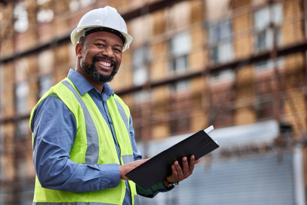 Portrait of a contractor filling out paperwork at a construction site Staying in the lines brics photos stock pictures, royalty-free photos & images