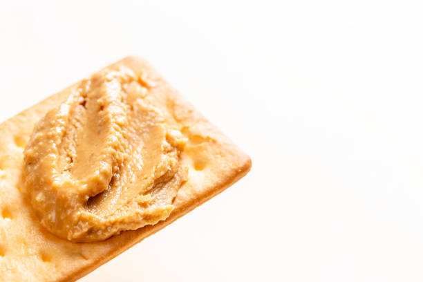 istock Peanut butter spread on soda crackers close up 1346008007