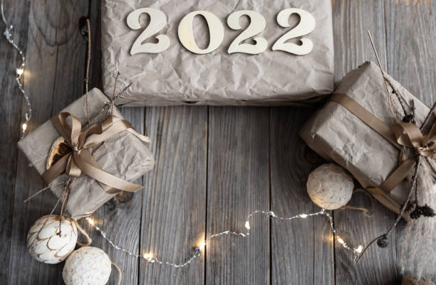 istock Christmas background with gift boxes and wood numbers 2022, flat lay. 1346009315