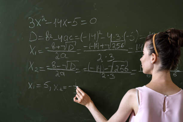 istock young female student written math formulas on the chalkboard 1346009639