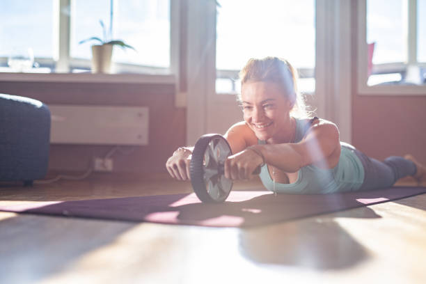 istock Sports woman doing ab roller exercise 1346009641