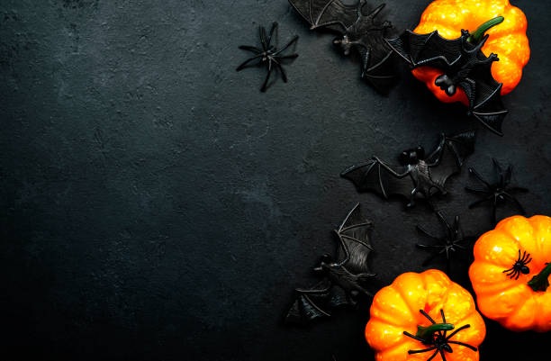 istock Happy Halloween black background with pumpkins, bats, spiders with copy space 1346009653