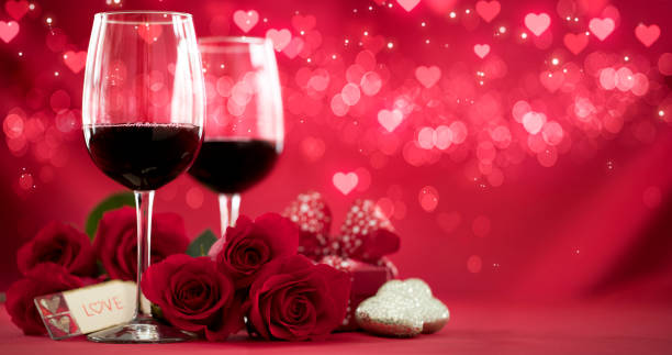 istock Valentine's Day Red Roses and Red Wine on a Defocused Lights Background 1346009893
