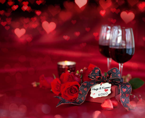 istock Valentine's Day Red Roses and Red Wine on a Defocused Lights Background 1346009951