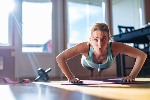 istock Woman doing push-ups at home 1346011091
