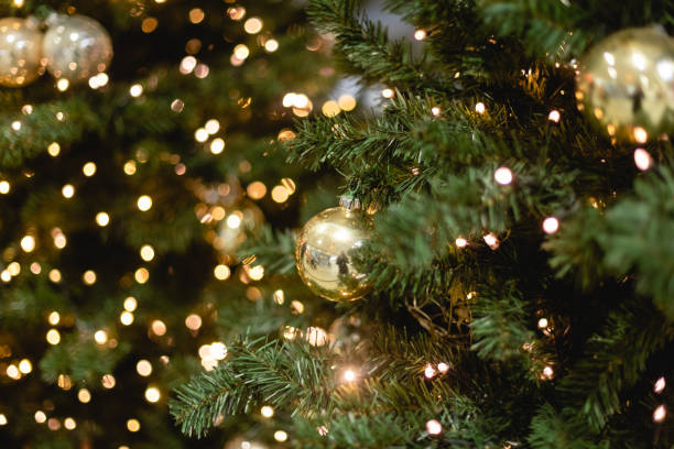istock Christmas tree decorations background for design template. Bright glowing lights, New year concept, toys and balls on the spruce tree 1346012091