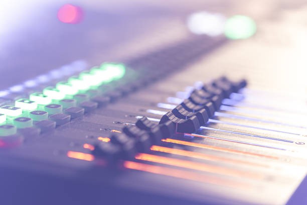 Professional audio mixing console with faders and controls.