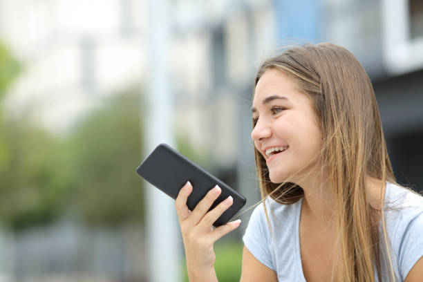 happy teen using voice recognition on smart phone - 聽寫 個照片及圖片檔