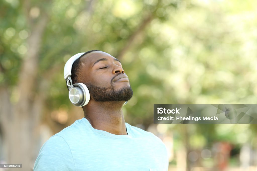 Happy black man listening audio guide and breathing Relaxation Stock Photo