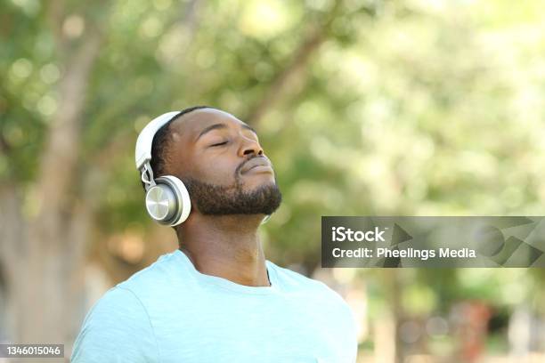 Happy Black Man Listening Audio Guide And Breathing Stock Photo - Download Image Now