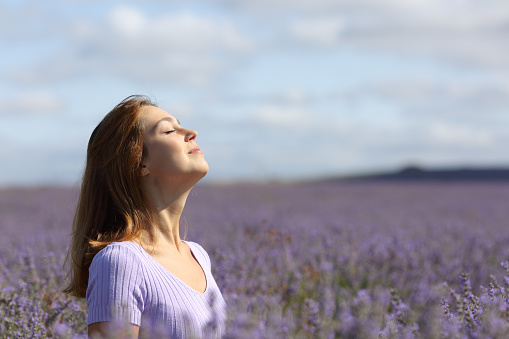 Beauty woman breathing in a lavender field