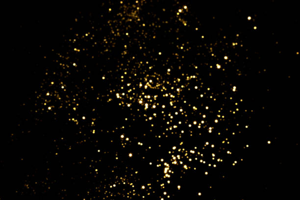 istock Golden blurred bokeh lights on black background 1346015225