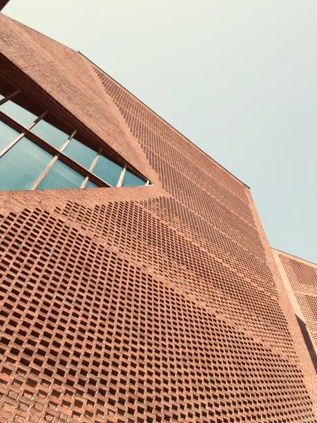 Completed 2013, by O’Donnell + Tuomey Architects. The building is designed to embody the dynamic character of a contemporary Student Union. The complex geometries of the site provided a starting point for an unconventional arrangement of irregular floor plates, each one particular to its function and each working into the next by an intricate system of trapezoidal spatial configuration.