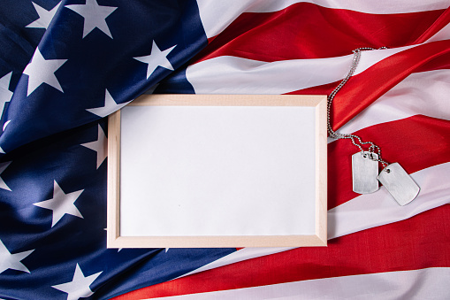 USA Memorial Day concept. Empty frame for text and American flag. Military dog tags.