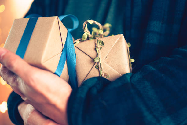 istock Hands holding gift box, present on the table and light of bokeh background. Valentine's Day, Christmas, Birth day, New year and Anniversary concept. 1346018155