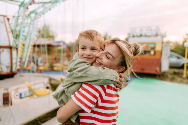 istock Hug with mommy at the amusement park 1346019568