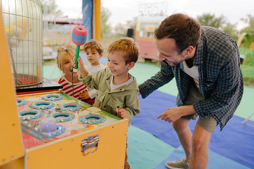 Photo of a happy family having fun at the traveling fair