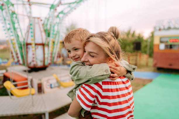 istock Hug with mommy at the amusement park 1346019573