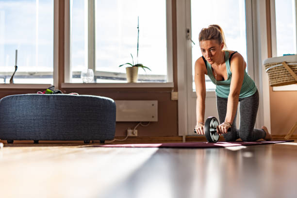 istock Sports woman doing ab roller exercise 1346020692