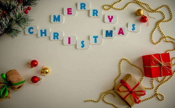 istock christmas background with gift boxes, christmas tree decorations, and the inscription merry christmas. Preparing for the holidays. Top view with copy space. 1346021954