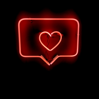 Red neon sign instagram like heart-shaped with black background. Social network concept