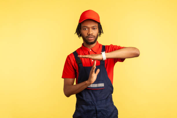 istock Worker showing time out gesture, need break, working in service industry, housekeeping maintenance. 1346023663