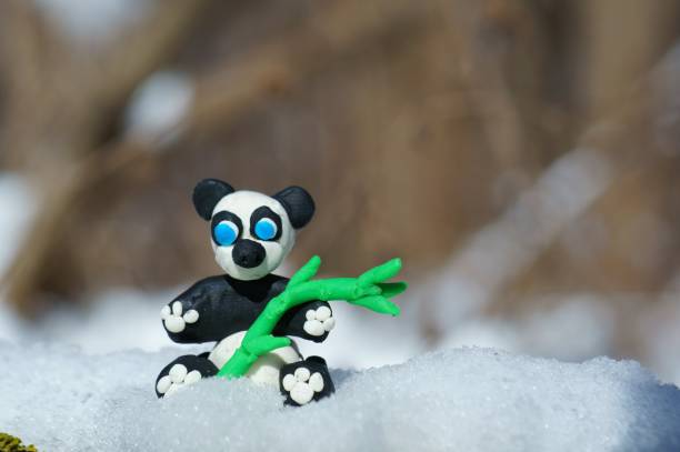 istock Panda figurine made of plasticine in a snowy forest. 1346023690
