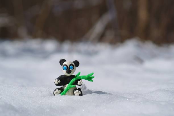istock Panda figurine made of plasticine in a snowy forest. 1346023691