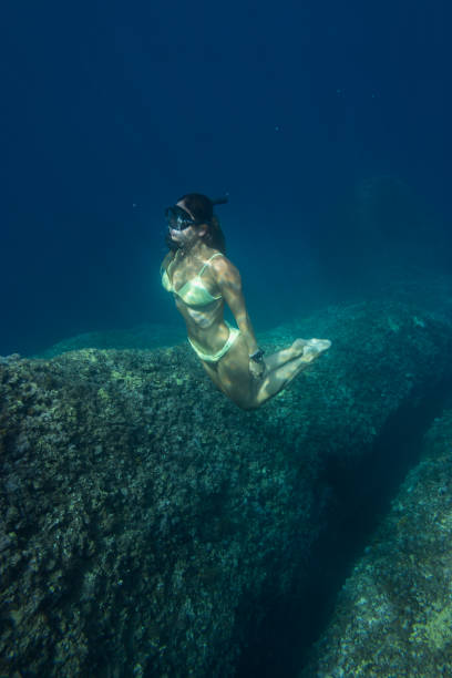 istock Woman swimming underwater 1346024465